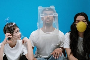 Three young adults wearing homemade faceshields